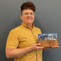 Nora Owen holding an ASLTA award