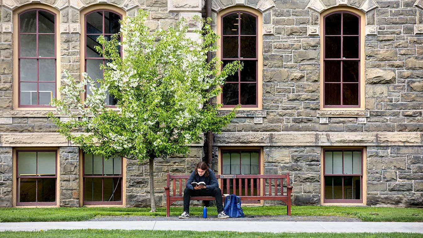 Student studying outside of Morrill Hall