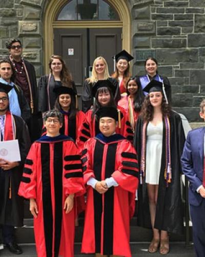 2019 Linguistics graduates pose on steps of Morrill Hall
