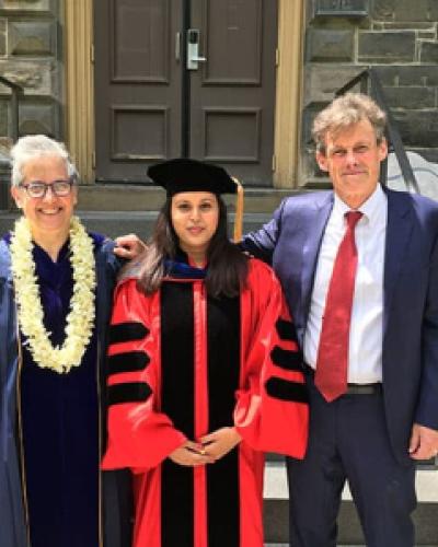 Abby Cohn, Shohini Bhattasali, and John Whitman pose in front of Morrill Hall on Commencement Day